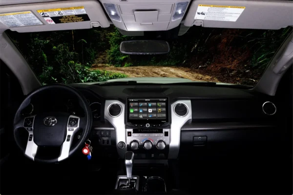 Inside a car with a Toyota Tundra (2014-2021) HEIGH10 10" Touch Screen Radio Plug-and-Play Kit steering wheel and dashboard.